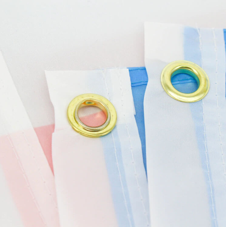 Close up of grommets on the trans pride flag.